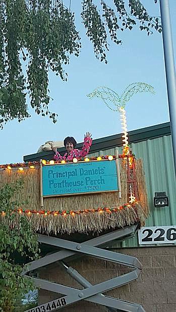 Carson Montessori School Principal Jessica Daniels was raised to the roof in a scissor lift decorated like a tropical island Wednesday evening. The next morning, students were greeted by Mrs. Daniels from her rooftop porch.
