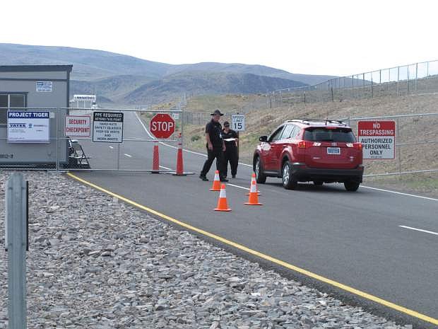 Security guards stop a car Friday Aug. 1, 2014, at the gate to the site Tahoe Reno Industrial Center about 15 miles east of Reno, Nevada where Tesla Motors has broken ground as one of the possible places to build a $5 billion &quot;gigafactory&#039;&#039; to make lithium batteries for its electric cars. (AP Photo/Scott Sonner)