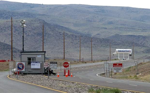 FILE - This Aug. 1, 2014 file photo shows security guards at the gate to the site Tahoe Reno Industrial Center about 15 miles east of Reno, Nevada. Tesla Motors has selected the site in Nevada for a massive, $5 billion factory that it will build to pump out batteries for a new generation of electric cars, a person familiar with the company&#039;s plans said Wednesday, Sept. 3, 2014. (AP Photo/Scott Sonner, File)