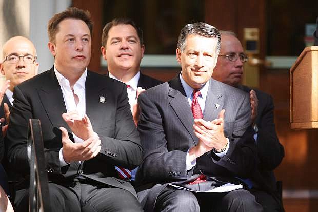 Tesla&#039;s Elon Musk, left, and Governor Brian Sandoval applaud during the press conference at the State Capitol last Thursday.