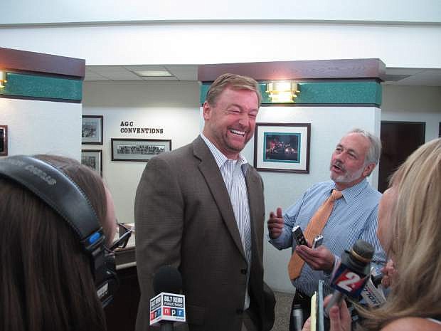 Sen. Dean Heller laughs with reporters Monda after meeting with a transportation round table sponsored by the Association of General Contractors at Granite Construction in Sparks. Among other things, he discussed efforts to lure Tesla Motors&#039; $5 billion lithium batter plant to Nevada. He warned a proposal to fund education with a 2 percent margins tax on corporations would undermine efforts to seal the deal.