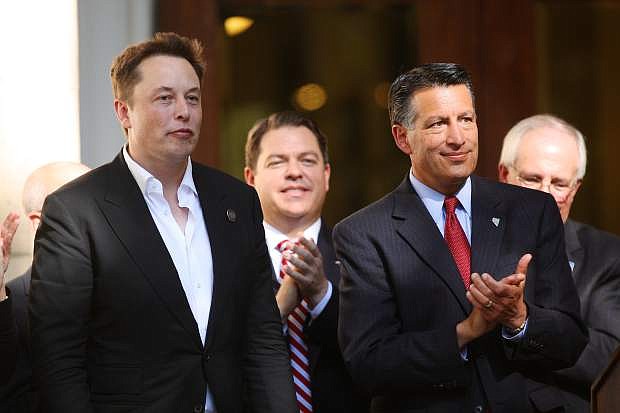 Tesla&#039;s Elon Musk, left, gets a standing ovation from Governor Brian Sandoval and the rest of the crowd at the State Capitol Thursday afternoon.