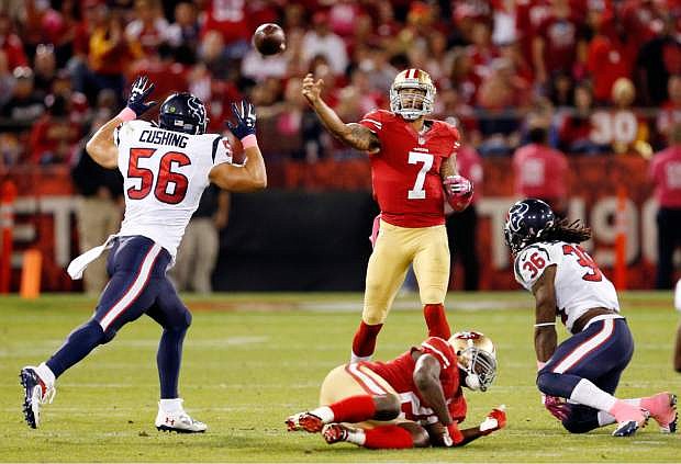 San Francisco 49ers quarterback Colin Kaepernick (7) throws a pass to Vernon Davis for a touchdown in the second half of an NFL football game against the Houston Texans in San Francisco, Sunday, Oct. 6, 2013. (AP Photo/Beck Diefenbach)