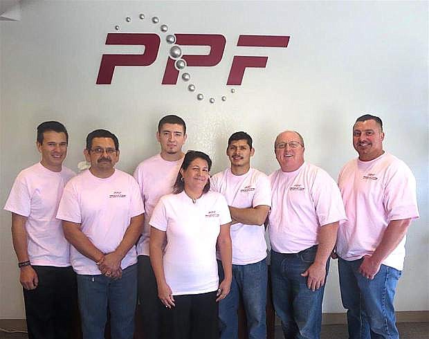 Production Pattern &amp; Foundry show off their pink breast cancer awareness shirts.