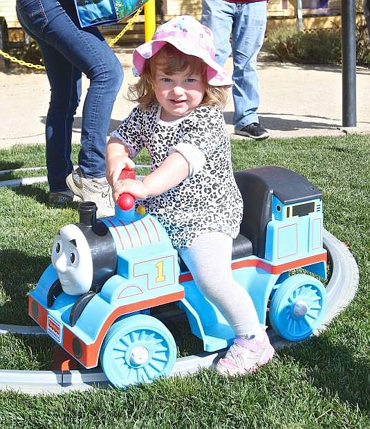 2-year-old Julia Marinucci of Rio Vista, Calif., rides an electric Thomas Friday at the Thomas and Friends event in Virginia City.