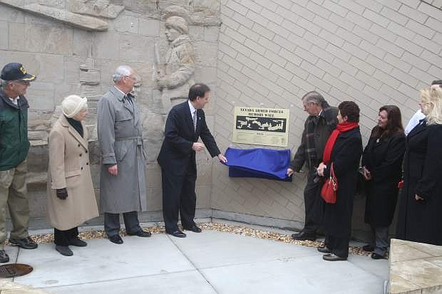 Lt. Gov. Brian Krolicki, left, and Tom Stephens unveil a new plaque at the Veterans Memorial on Monday.