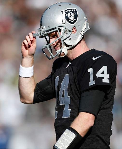 Oakland Raiders quarterback Matt McGloin (14) walks to the sideline after being intercepted by Tennessee Titans outside linebacker Zach Brown during the second quarter of an NFL football game in Oakland, Calif., Sunday, Nov. 24, 2013. (AP Photo/Beck Diefenbach)