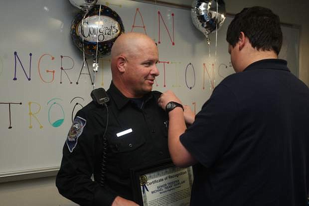 Nevada Highway Patrol Trooper Michael &quot;Sean&quot; Giurlani is pinned with badge No. 1 by his 14-year-old son Jacob on Monday. Giurlani was recognized as being the most senior trooper in the state with more than 25 years of service.