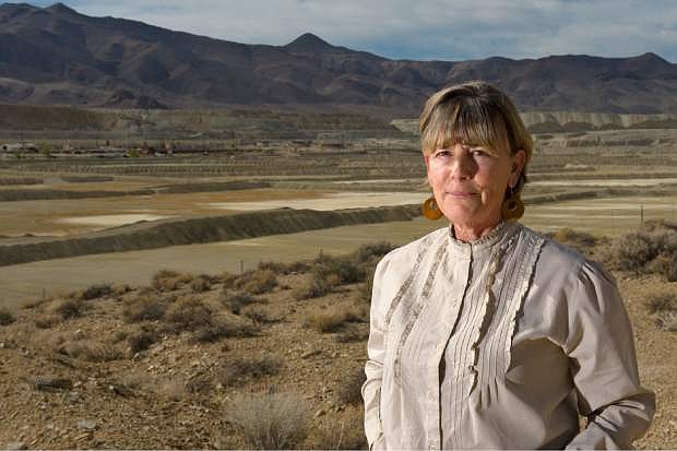 FILE - In this Oct. 26, 2009, file photo, Peggy Pauly, who formed Yearington&#039;s first citizen advocacy group to address the water contamination from the former Anaconda copper mine site near Yearington, Nev., is pictured in front of the leach ponds that are responsible for most of that contamination. Fifteen years after U.S. regulators started assessing damage and health risks at an abandoned Nevada copper mine, the Environmental Protection Agency is moving to add the contaminated site to its Superfund National Priority List, according to documents obtained by The Associated Press. (AP Photo/Scott Sady, File)