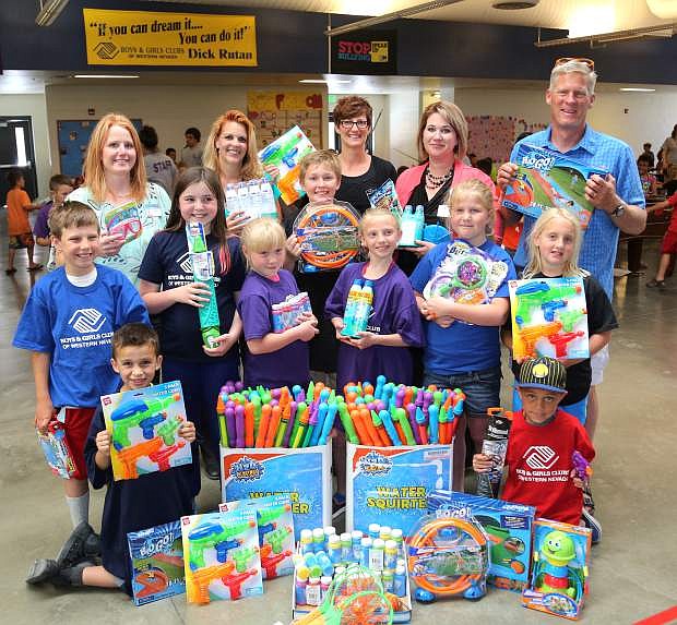 Boys &amp; Girls Club members display suncreen and water toys that were donated to the club from employees at Carson Tahoe Health. Pictured in the back, from left, are Valerie Farris, Carson Tahoe Health, Lorri Baker, Carson Tahoe Health, Katie Leao, Boys &amp; Girls Club, Kayleen Fogleman, Carson Tahoe Health and Kurt Meyer, Boys &amp; Girls Club.