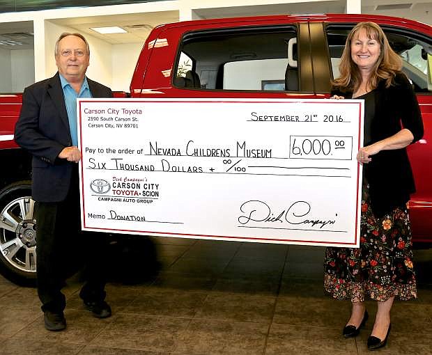 Carson City Toyota General Manager Dana Whaley presents a check to Lu Olsen, director of the Children&#039;s Museum of Northern Nevada on Wednesday in Carson City. The $6,000 donation wil be used as a downpayment for a new learning exhibit. If you would like to donate to the cause, call 884-2226.