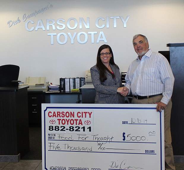 Marlene Maffei, executive director of Food for Thought, accepts a check for $5,000 from Dick Campagni on behalf of Carson City Toyota.