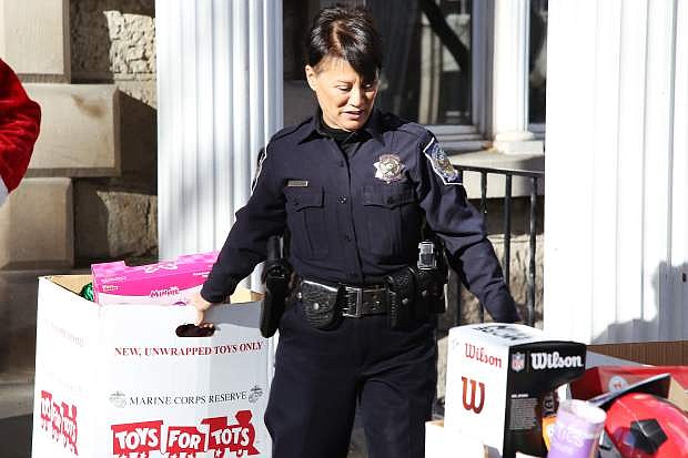 Capitol Police officer Alice Valdez with some of the toys donated in this year&#039;s toys for tots drive at the capitol.