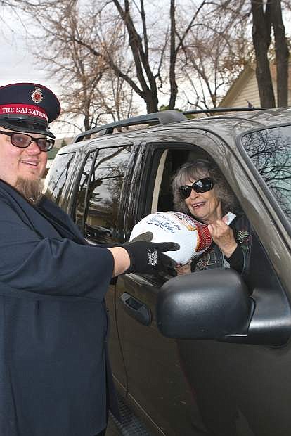 Salvation Army Lt. Mark Cyr takes a donated turkey from Pam Gardner of Carson City on Wednesday at Mike&#039;s Pharmacy. This is the 16th year of the &#039;Turkey Roundup&#039;.