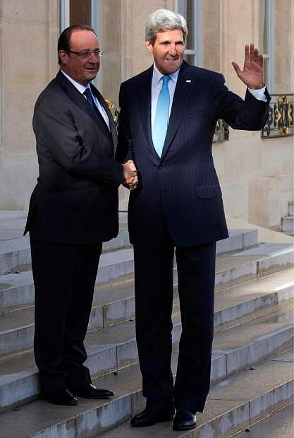 French President Francois Hollande, left, welcomes U.S. Secretary of State John Kerry for a meeting on Syria at the Elysee Palace in Paris, Monday, Sept. 16, 2013. (AP Photo/Michel Euler)