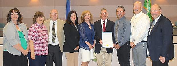The Churchill County Commissioners issued a proclamation calling for Thrusday to be University of Nevada Cooperative Extension Day in recognition of its 100th birthday. From left are Karen Bogdanowicz, UNCE; Pat Whitten, UNCE; Commissioner Bus Scharmann; Claudente Wharton, UNCE communications speacialist; Pam Powell, UNCE education; Mark Wheeler, UNCE interim director; Commissioner Carl Erquiaga; Jay Davison, crop specialist; and Commissioner Pete Olsen.