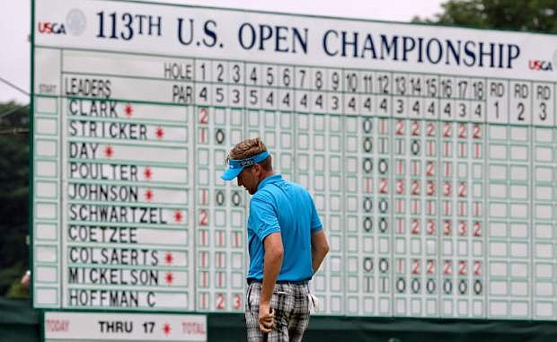 Ian Poulter, of England, reacts after missing a putt on the 18th hole during the first round of the U.S. Open golf tournament at Merion Golf Club, Thursday, June 13, 2013, in Ardmore, Pa. (AP Photo/Charlie Riedel)