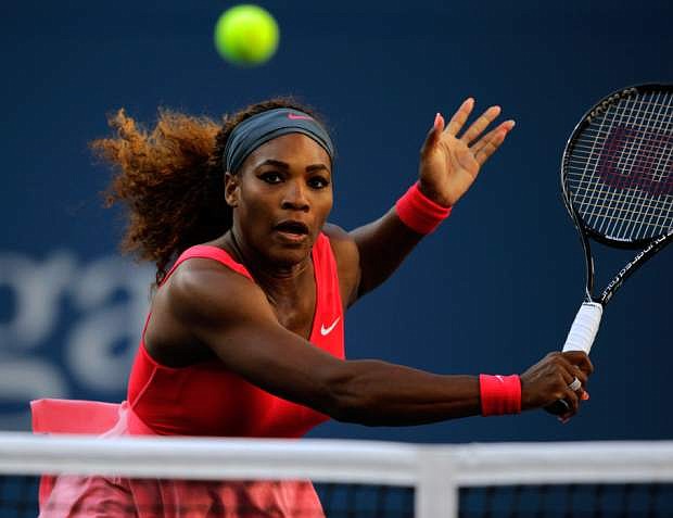 Serena Williams returns a shot to Li Na, of China, during the semifinals of the 2013 U.S. Open tennis tournament, Friday, Sept. 6, 2013, in New York. (AP Photo/Charles Krupa)