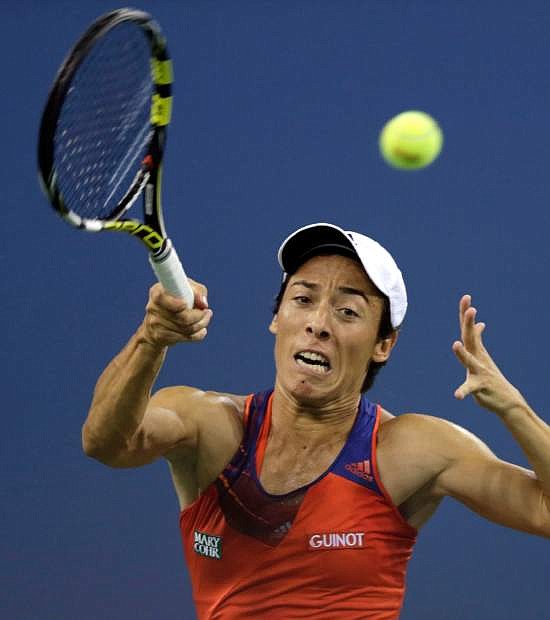 Francesca Schiavone, of Italy, returns to Serena Williams, of the United States, during the first round of the 2013 U.S. Open tennis tournament, Monday, Aug. 26, 2013, in New York. (AP Photo/Charles Krupa)