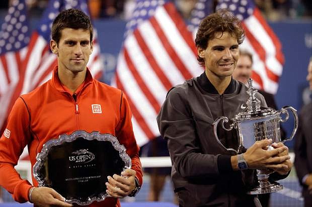 Novak Djokovic, of Serbia, and Rafael Nadal, of Spain, pose for photos after Nadal won the men&#039;s singles final of the 2013 U.S. Open tennis tournament, Monday, Sept. 9, 2013, in New York. (AP Photo/David Goldman)