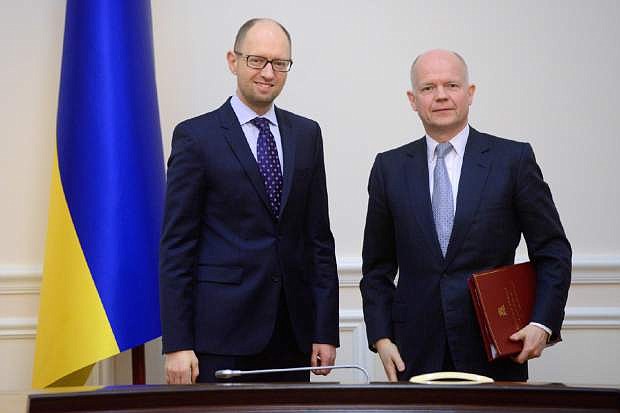 Ukrainian Prime Minister Arseniy Yatsenyuk, left, and British Foreign Secretary William Hague pose for a photograph prior to their meeting in Kiev, Ukraine, Monday, March 3, 2014. Pro-Russian troops took over a ferry terminal on the easternmost tip of Crimea close to Russia on Monday, exacerbating fears that Moscow is planning to bring even more troops into this strategic Black Sea region. (AP Photo/Andrew Kravchenko, Pool)