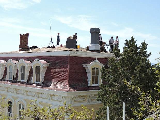 Workers and others atop the Victorian era Savage Mansion in Virginia City deal with roofing challenges at the structure owned there by Hugh Roy Marshall, who also has Marshall Mint &amp; Museum. The mansion work was done after recent storm water damage, according to the Storey County Building Department, which did some inspection work there Friday. The department identified the roofer as Tom Goldston Roofing in Gardnerville.