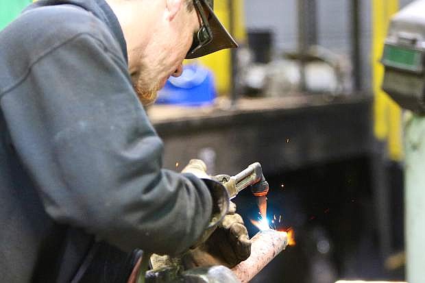 V&amp;T contractor Andy Williamson of Fillmore, Calif., welds some piping to be used for a railing on McCloud #18.
