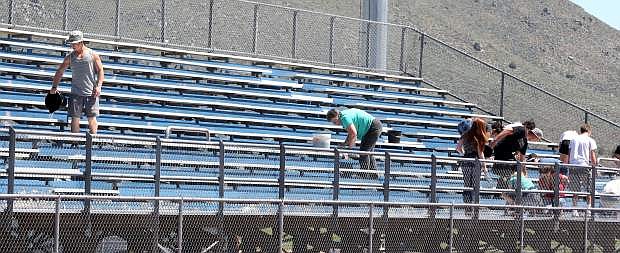 About 25 Douglas High School students volunteered to help remove spray paint from the Carson High School football and track stadium.