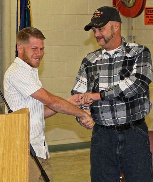 Veteran Michael Atkinson, the last recipient of a vehicle from the Recycled Rides program at WNC, presents the keys to latest veteran recipient Joseph Davis Alton III Wednesday morning at Western Nevada College.