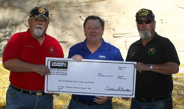 Michael Houdyshell, center, with Coldwell Banker Select presents a check for $637 to Vietnam Veterans of America Chapter 388 president Frank Reynolds, left, and vice-president Tom Spencer on Tuesday. The money was raised through donations during the Nevada Day parade. The chapter provides numerous outreach programs for all veterans. For more information on the local Vietnam Veterans of America Chapter 388, call 885-6876.