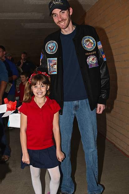 1st grader Kaia Cluff readies to present her Navy veteran father Matthew Cluff to the audience at Seeliger Elementary Friday.