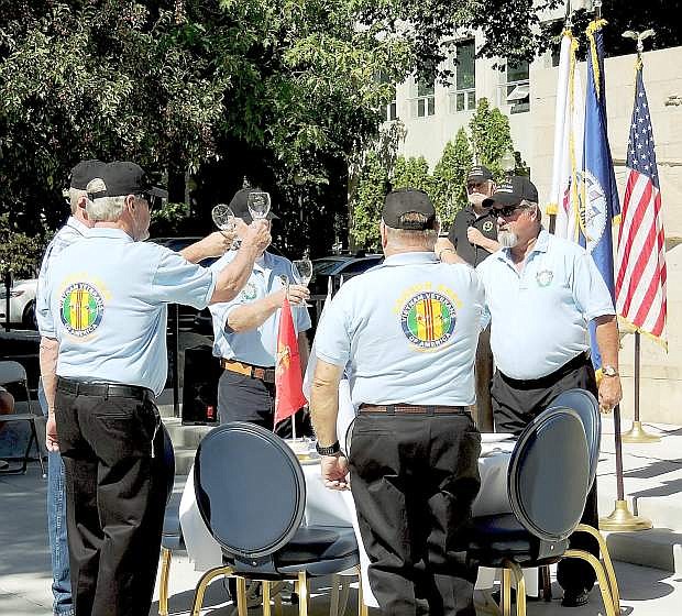 Members of The Vietnam Veterans of America-Carson Area Chapter 388 perform the Missing Warrior Table and Honors Ceremony after remarks by Mayor Robert Crowell and others at the Nevada State Veterans Memorial.