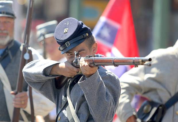 Austin Smith, 16, a Civil War reenactor takes aim during a street battle in  Virginia City on Monday.
