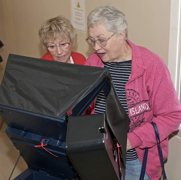 Election volunteer Donna Hataway, left, helps Marla Myles of Carson City with her ballot Saturday at the courthouse. Early voting for the June 14 primary election will resume Tuesday at the courthouse.