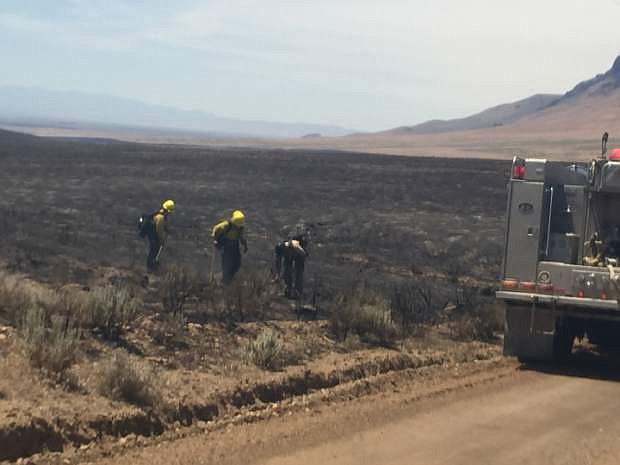 Fire crews tend to hot spots Monday, July 4, 2016 on the perimeter of a wildfire that has consumed 185 square miles of rangeland in north-central Nevada. More than 250 crew members were fighting the blaze that burned within a few hundred yards of ranch homes near the town of Midas about 35 miles north of Battle Mountain, but there have been no reports of injuries or structure damage. (Rudy Evenson/ U.S. Bureau of Land Management via AP)