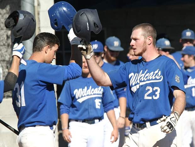Corey Pool is congratulated by his teammates at home plate after hitting a solo home run in the 5th inning against Sierra College on Tuesday.