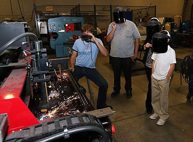 Visitors watch a welding demonstration during Manufacturing Day last year at Western Nevada College in Carson City.