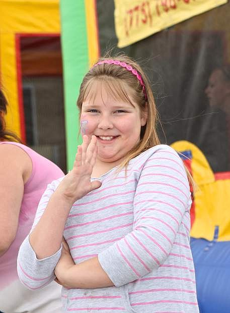 8-year-old Mariah Fraker signs &#039;Cool&#039; at WNC Deaf Studies &#039;Fun Day&#039; held at the Carson campus. The event featured a bounce house, photo booth, face painting, arts and crafts, food and raffles Saturday.