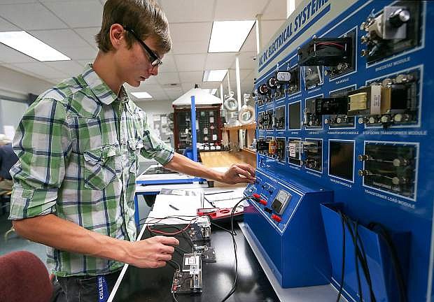 Western Nevada College student CJ Straw builds and tests an electrical circuit in the Applied Industrial Technology program hands-on lab class.
