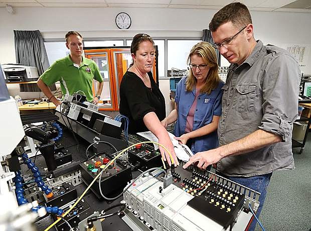 From left, Brendan Flayer, Lindsay Moore, Professor Emily Howarth and Matt Anderson work in the industrial technology labs at Western Nevada College in Carson City last fall.