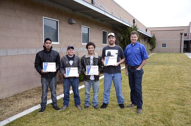 Western Nevada College students, from left, Luis Pacheco, Michael Atkinson, Devin White and Jeremy Taylor earned Auto Service Excellence certifications after taking Automotive Mechanics classes from instructor Jason Spohr, right. Atkinson was one of four students to pass all nine certification exams.