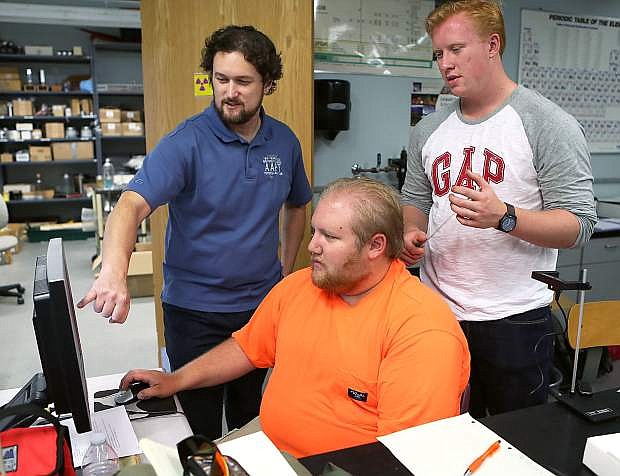 Physics Professor Tom Herring works with students Kyle Hollingshead and Timothy Hoover at Western Nevada College in Carson City.