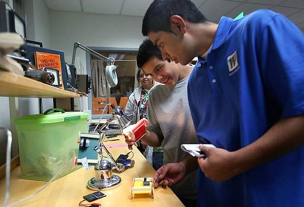 Student Ambassador Javier Garcia, right, and Alejandro Gonzalez check out solar cars during Manufacturing Day at Western Nevada College on Thursday.