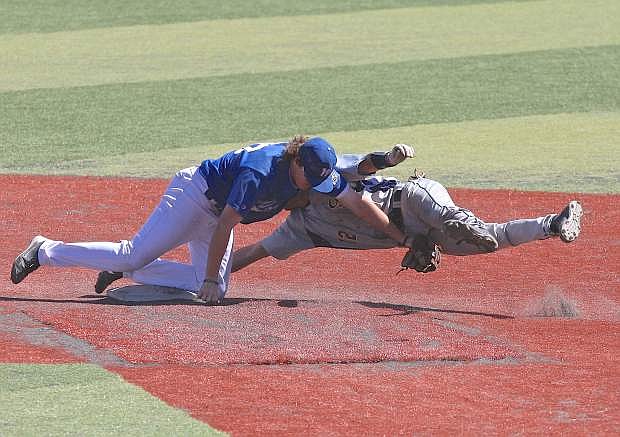 Shortstop Kody Reynolds upends a CSN baserunner Friday at John L. Harvey Field. The Wildcats lost game one of the doubleheader to the Coyotes in extra innings, 2-1.