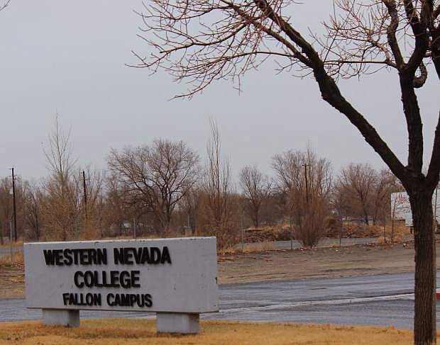 The familiar Western Nevada College sign welcomes students and visitors on a rainy wintry day this week. Whileprograms are beginningto increase, educators, though,are worried that the eliminationof bridge funding could be disastrous.