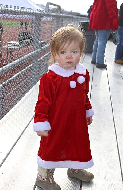 Kaylee Rogacs, 18 mos., is ready to be part of the human Christmas tree at Carson High Saturday.