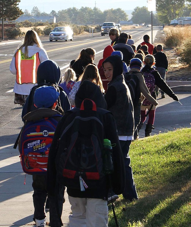 A group of Fremont students walk down Little Lane on their way to school Wednesday. The students had the option to walk to school Wednesday morning in an effort to get kids moving more for Nevada Moves Day.