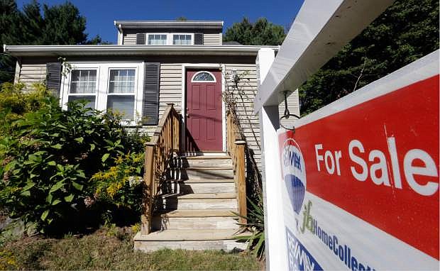 FILE - In this Wednesday, Sept. 18, 2013, file photo, a &quot;For Sale&quot; sign hangs in front of a house in Walpole, Mass.  Standard &amp; Poor&#039;s/Case-Shiller reports on U.S. home prices in September, on Tuesday, Nov. 26, 2013. (AP Photo/Steven Senne, File)