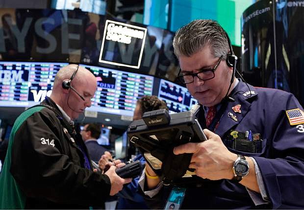FILE - In this April 30, 2014 file photo, traders Kevin Walsh, left, and John Panin work on the floor of the New York Stock Exchange. Stocks are edging higher in early trading Thursday, May 8, 2014, after investors were mostly pleased by the latest U.S. corporate earnings news.  (AP Photo/Richard Drew, File)