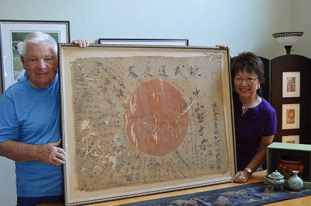 Carson City Host Lions Club member, Sam Herceg, left, displays a historical Japanese war flag with his wife, Ayako, right, purchased from vintage shop Kaleidoscope at 210 S. Carson St.
